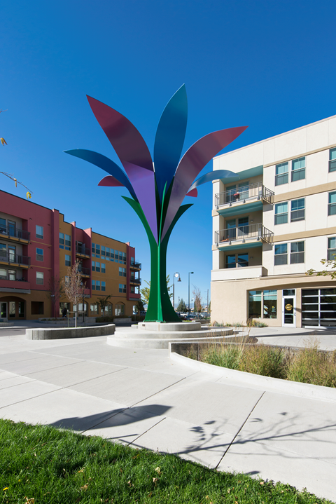 a large flower sculpture in the middle of an apartment building