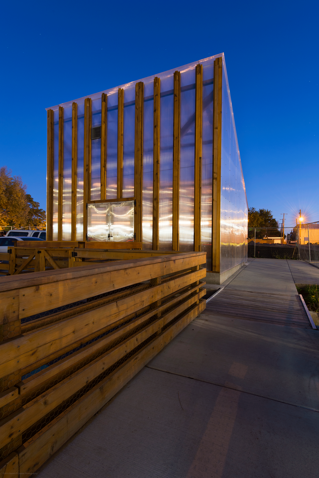 the exterior of a building at night with the windows lit up