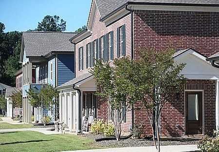 a brick house with trees in front of it