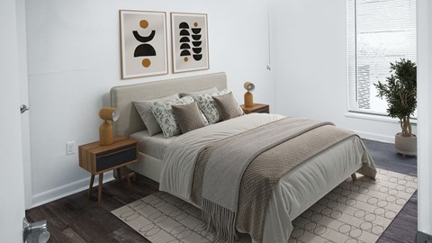 A bedroom with a bed, pillows, a nightstand, and a plant.