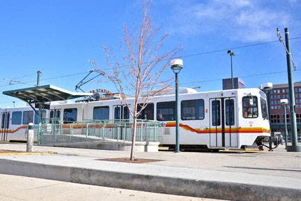 a white train is parked at a train station