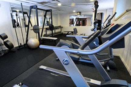 a gym with a bunch of exercise equipment in it