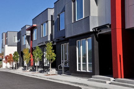 a row of new condos on the side of a street