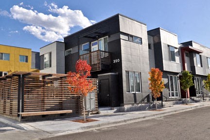 a row of houses with a street in front of them