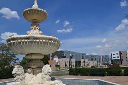 a statue of a fountain in a park