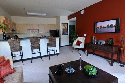 a living room with a kitchen and a table
