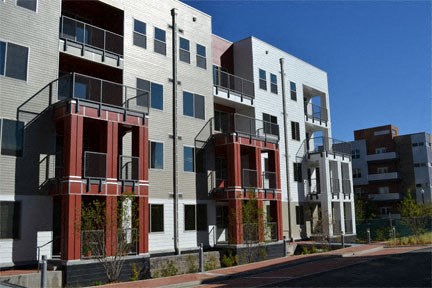 a row of new apartment buildings on a city street