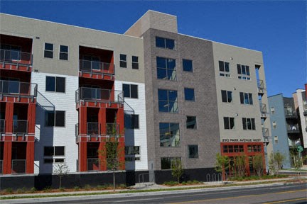 an apartment building with red and white balconies