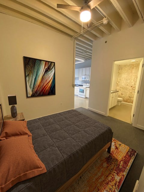 a bedroom with a bed and a painting on the wall at Lofts at Union Alley, Memphis