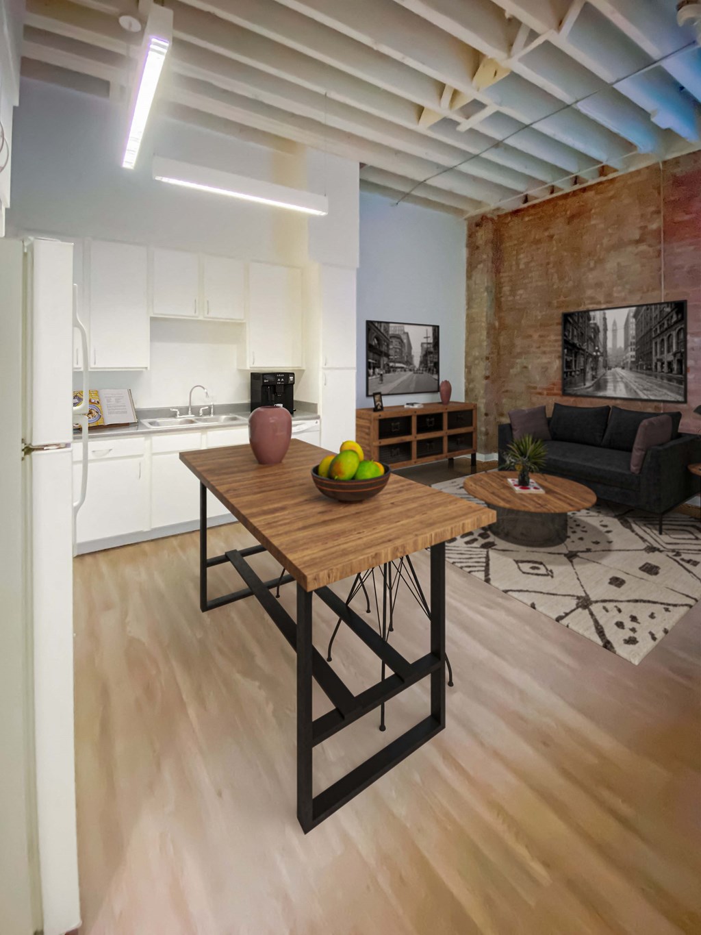 a kitchen and living room with a wooden table at Lofts at Union Alley, Memphis, 38103