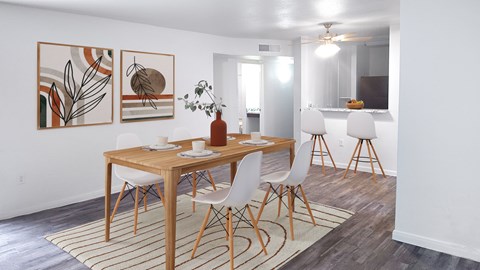 A dining room with a wooden table and chairs.