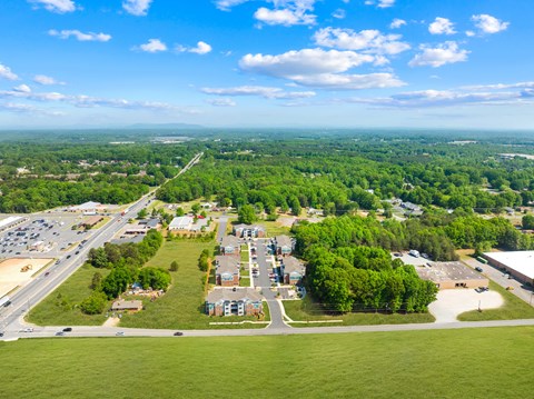A bird's eye view of a small town with a road running through it.