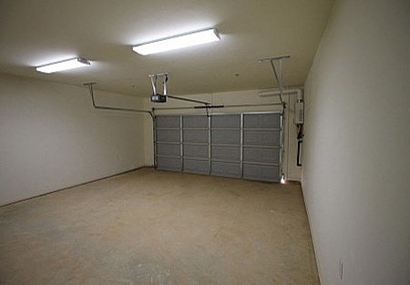 an empty room with a garage door in it