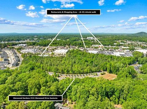 An aerial view of a location with a Restaurants & Shopping Area and Glenwood Gardens.