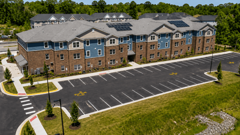 A large building with a parking lot in front of it.