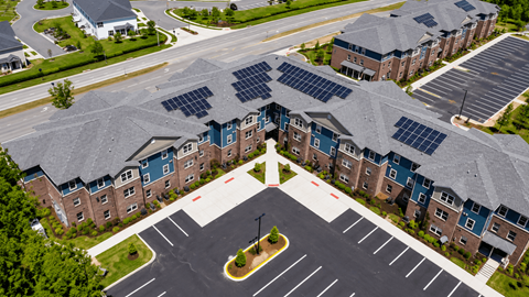 A large building with solar panels on the roof.