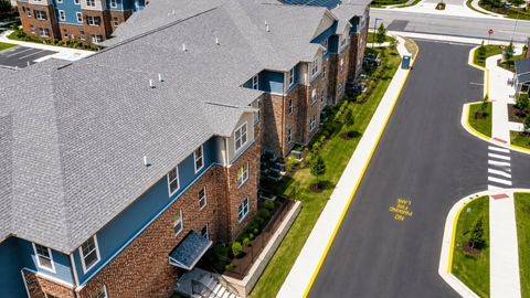 A street view of a residential area with apartment buildings.
