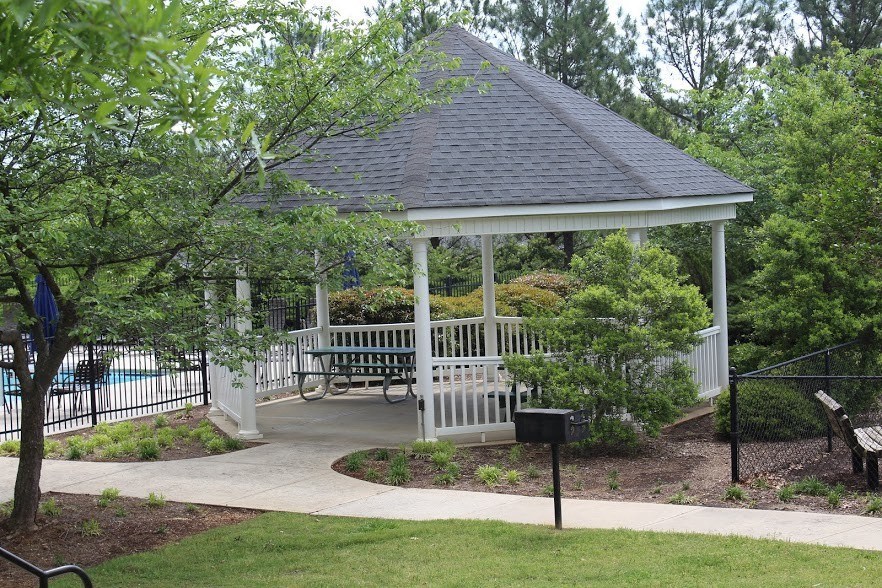 a gazebo in a park with benches