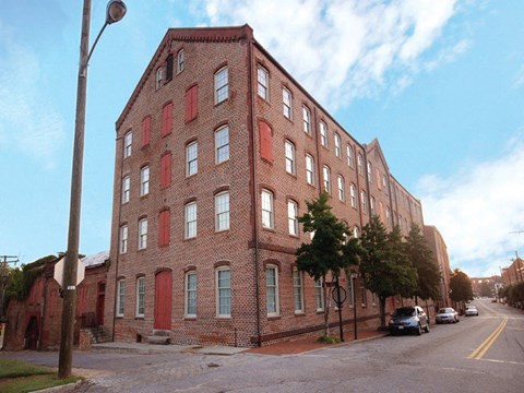 a large brick building on the side of a street