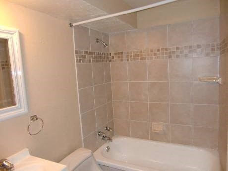 a bathroom with a tub and a toilet and a sink