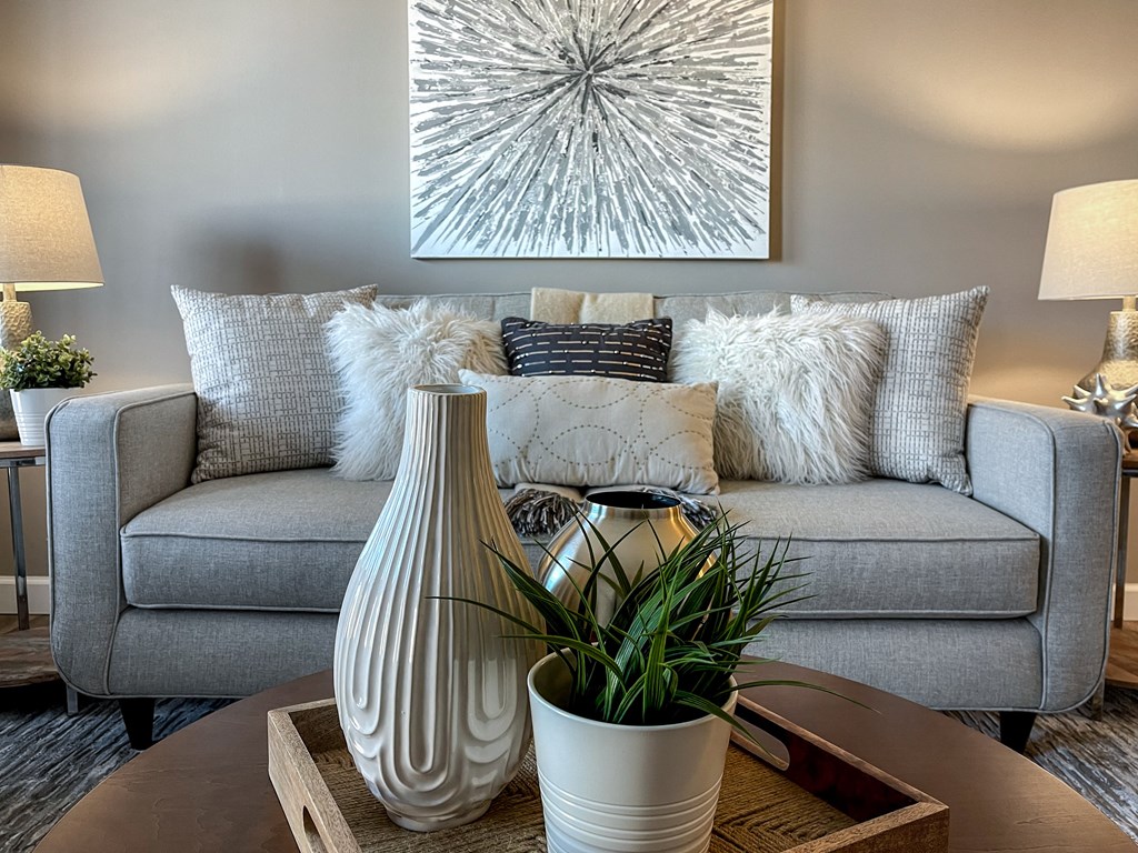 a living room with a gray couch and a table