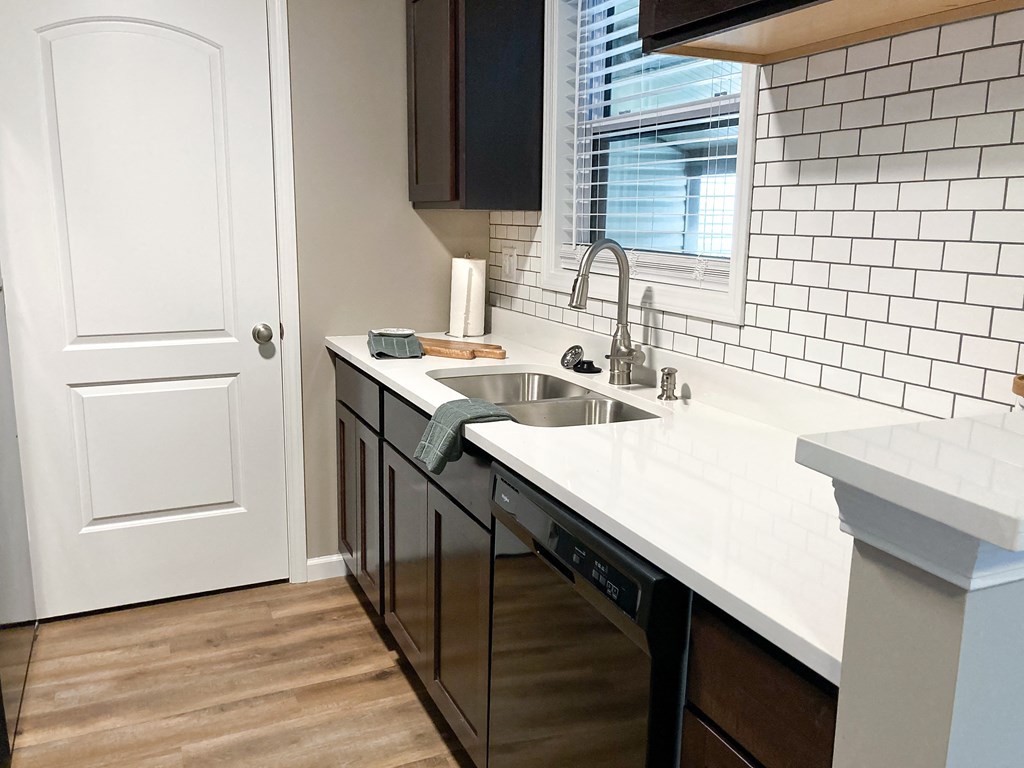 an empty kitchen with a sink and a window