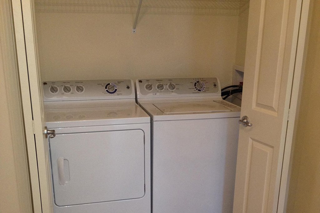 the laundry room has two washes and a dryer in it