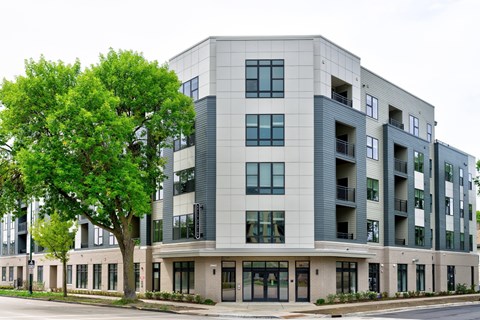 A modern building with a tree in front of it.