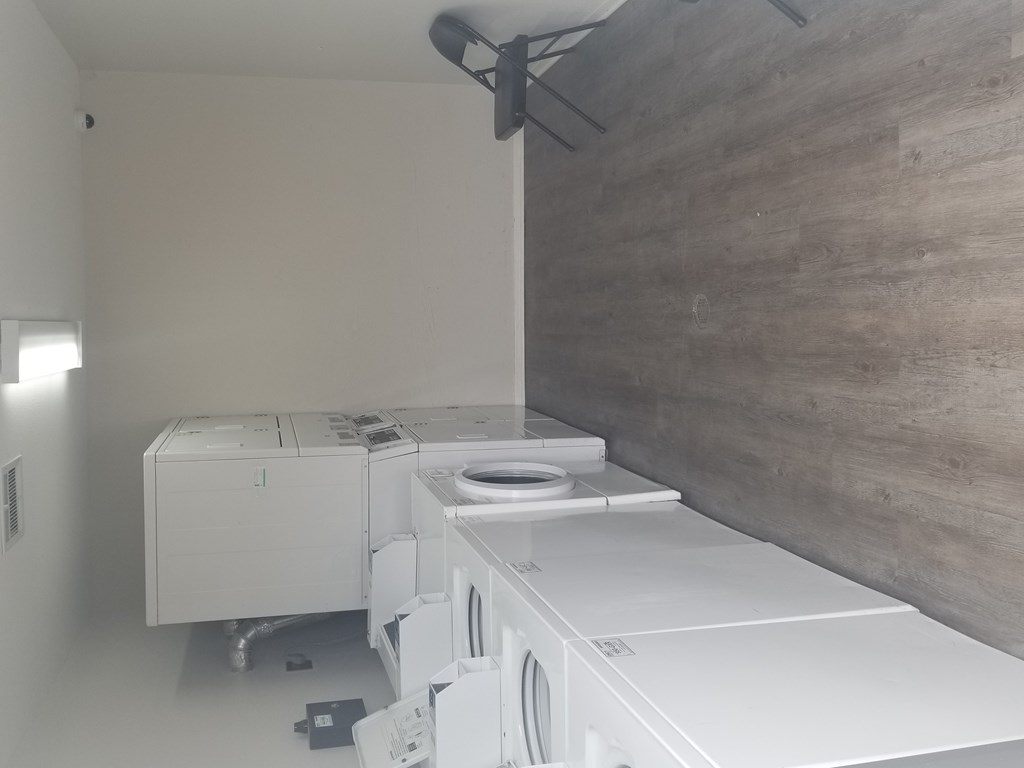 A row of washing machines in a laundromat.