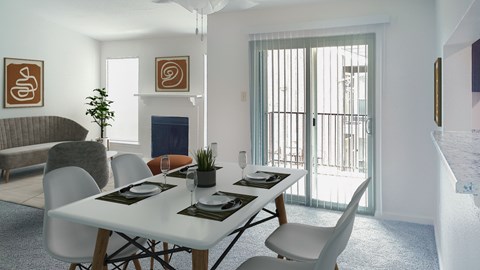 A dining room with a white table and chairs.