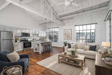 A modern open plan living and kitchen area with a dining table and chairs.