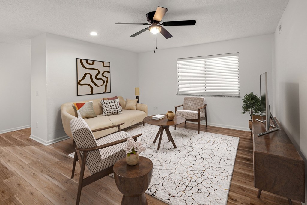 A living room with a couch, chairs, and a rug.at Mammoth at the Orchard Apartments, Rogers Arkansas  