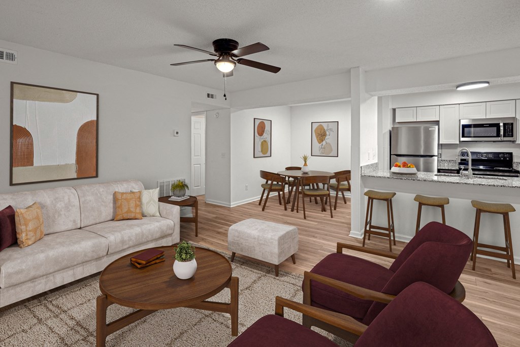 A living room with a couch, chairs, and a coffee table.at Mammoth at the Orchard Apartments, Rogers  