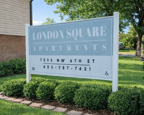 A sign for London Square Apartments is displayed in front of a building.