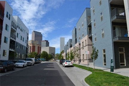 a city street with buildings and cars parked on the side of it