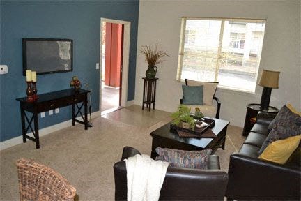 a living room with leather furniture and a television