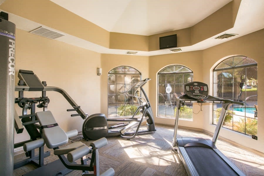Fitness center with a pool view