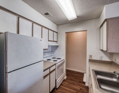 a kitchen with a stove and a refrigerator