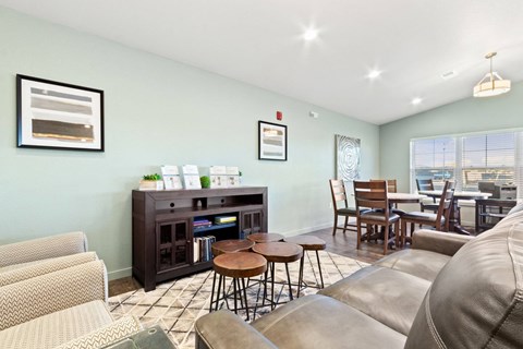 A living room with a brown leather couch and a wooden coffee table.