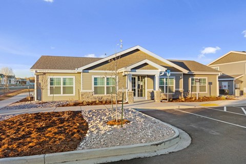 A building with a brown roof and a grey stone border in front.