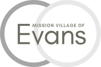 A black and white logo for the Mission Village of Evans.