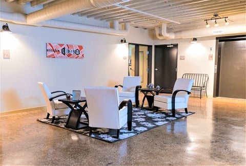 A conference room with a white table and chairs.