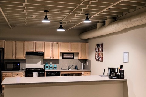 A kitchen with a white counter and wooden cabinets.