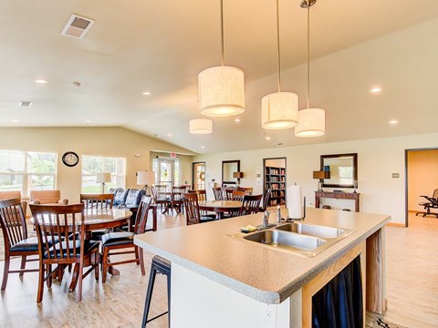 A kitchen with a bar area and a dining table.