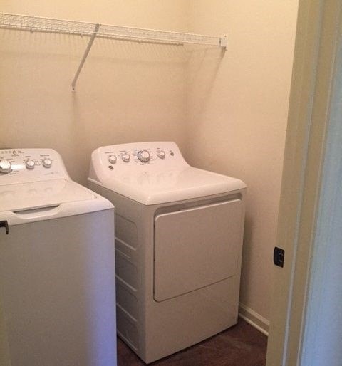 a white washer and dryer in a small laundry room