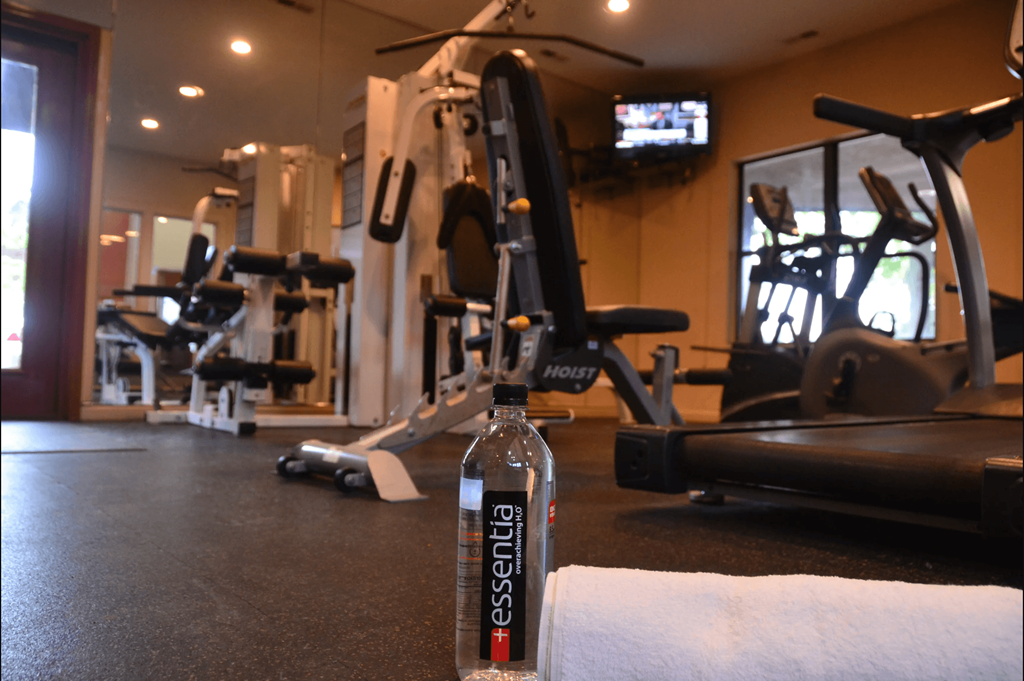 a bottle of energy drink sitting on a counter in a gym