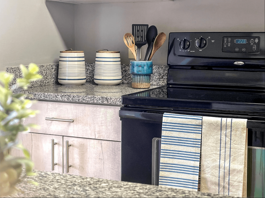a kitchen with an oven and a counter top with a sink