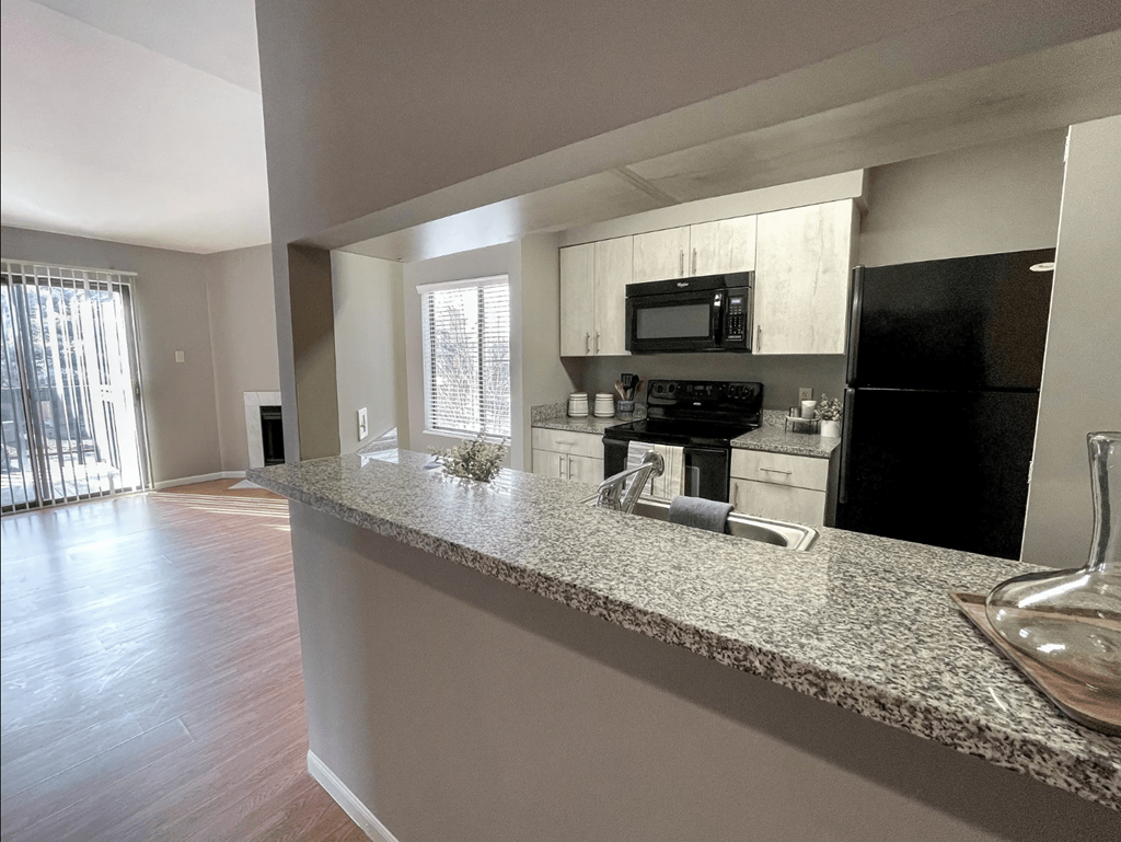 an open kitchen with a granite counter top