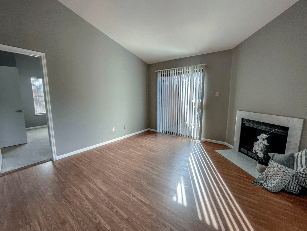 a living room with wood flooring and a fireplace