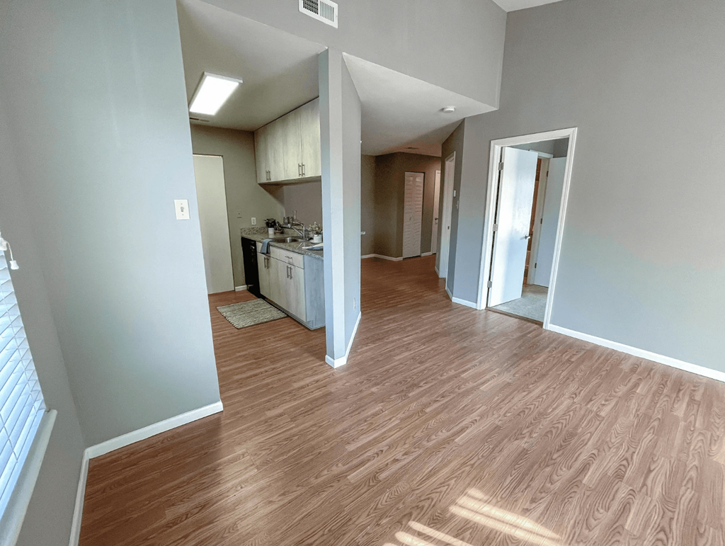 a view from the living room into the kitchen and dining room